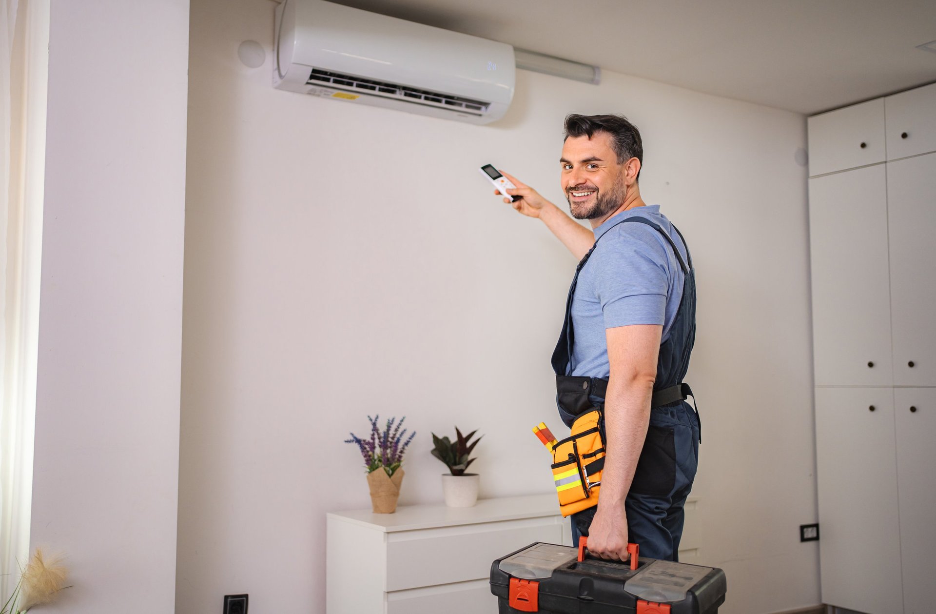 HVAC technician installing air conditioner